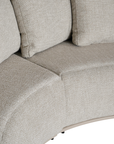 Laguna modular sofa in oat drift fabric with curved form and soft cushions on a clean background.