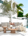 Laguna sofa in sand stripe fabric styled with Tarran coffee table and side table in nomad dune creating a soft neutral outdoor living setting.
