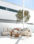 Laguna sofa in sand stripe fabric styled with Tarran coffee table and side table in nomad dune creating a soft neutral outdoor living setting.
