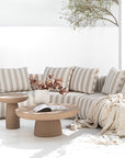 Laguna sofa in sand stripe fabric styled with Tarran coffee table and side table in nomad dune creating a soft neutral outdoor living setting.