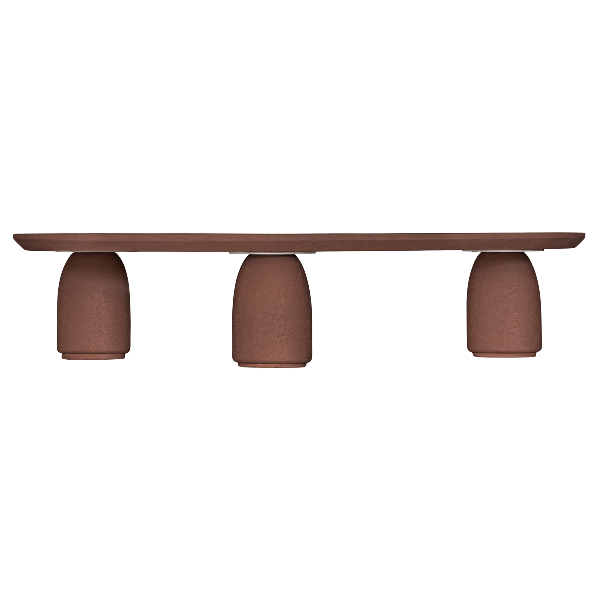 Lantara coffee table in cinnabar clay finish with elongated oval top and three rounded sculptural legs.