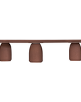 Lantara coffee table in cinnabar clay finish with elongated oval top and three rounded sculptural legs.
