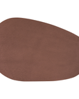Lantara coffee table in cinnabar clay finish with elongated oval top and three rounded sculptural legs.