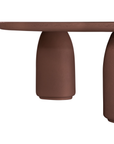 Lantara coffee table in cinnabar clay finish with rounded top and three rounded sculptural legs.