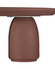 Lantara coffee table in cinnabar clay finish with rounded top and three rounded sculptural legs.