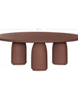 Lantara coffee table in cinnabar clay finish with rounded top and three rounded sculptural legs.