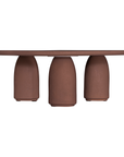 Lantara coffee table in cinnabar clay finish with rounded top and three rounded sculptural legs.
