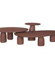 Lantara side table in a cinnabar clay finish with round top and elongated sculptural leg.