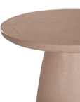 Lantara side table in nomad dune with tapered sculptural base and rounded top shown in a clean minimal setting.