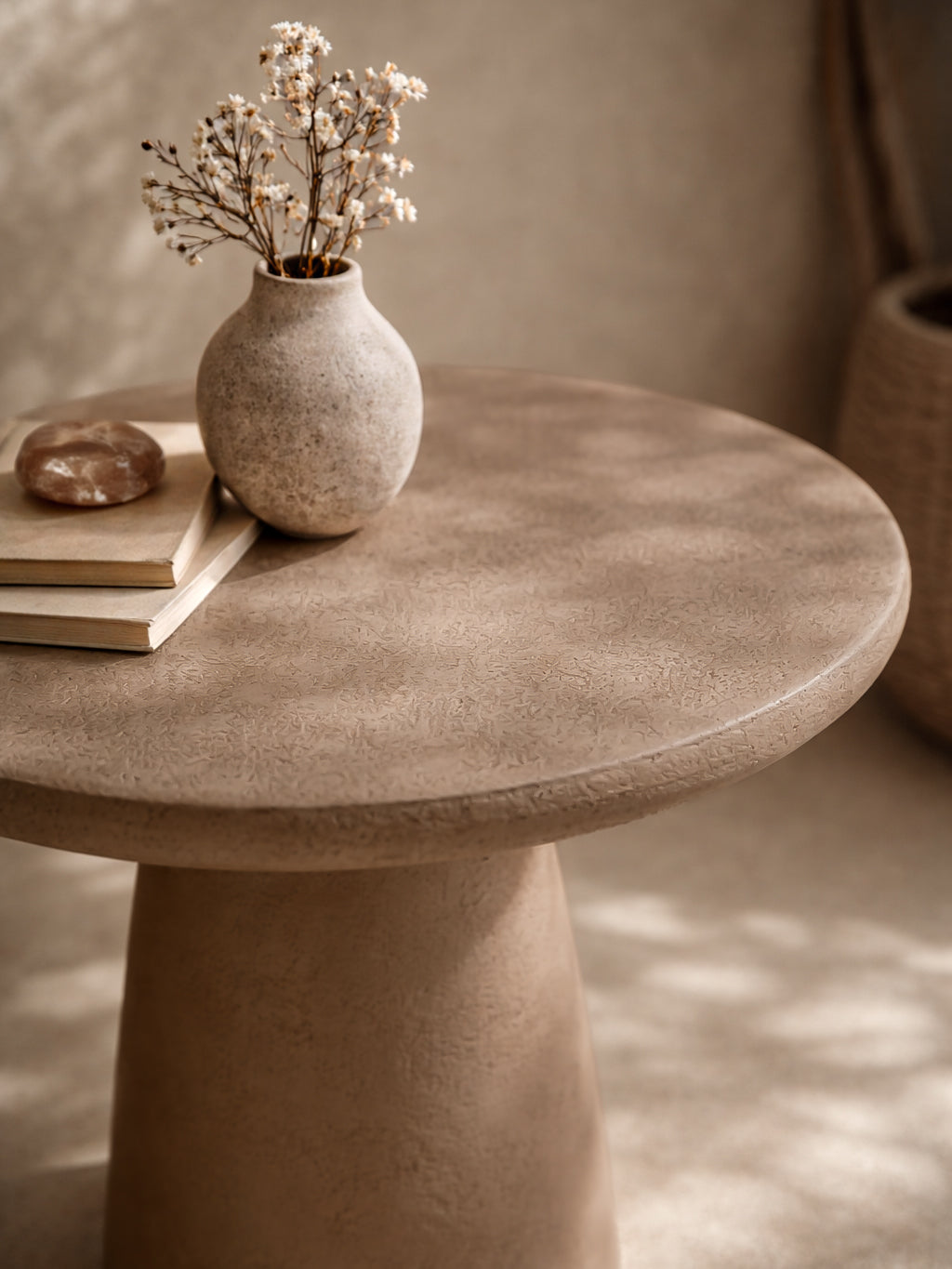 Lantara side table in nomad dune finish styled with a ceramic vase in a warm neutral interior setting.