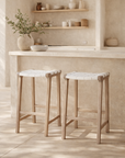 Lazzy barstool in natural timber with white woven seat styled at a mediterranean inspired kitchen island with soft neutral textures