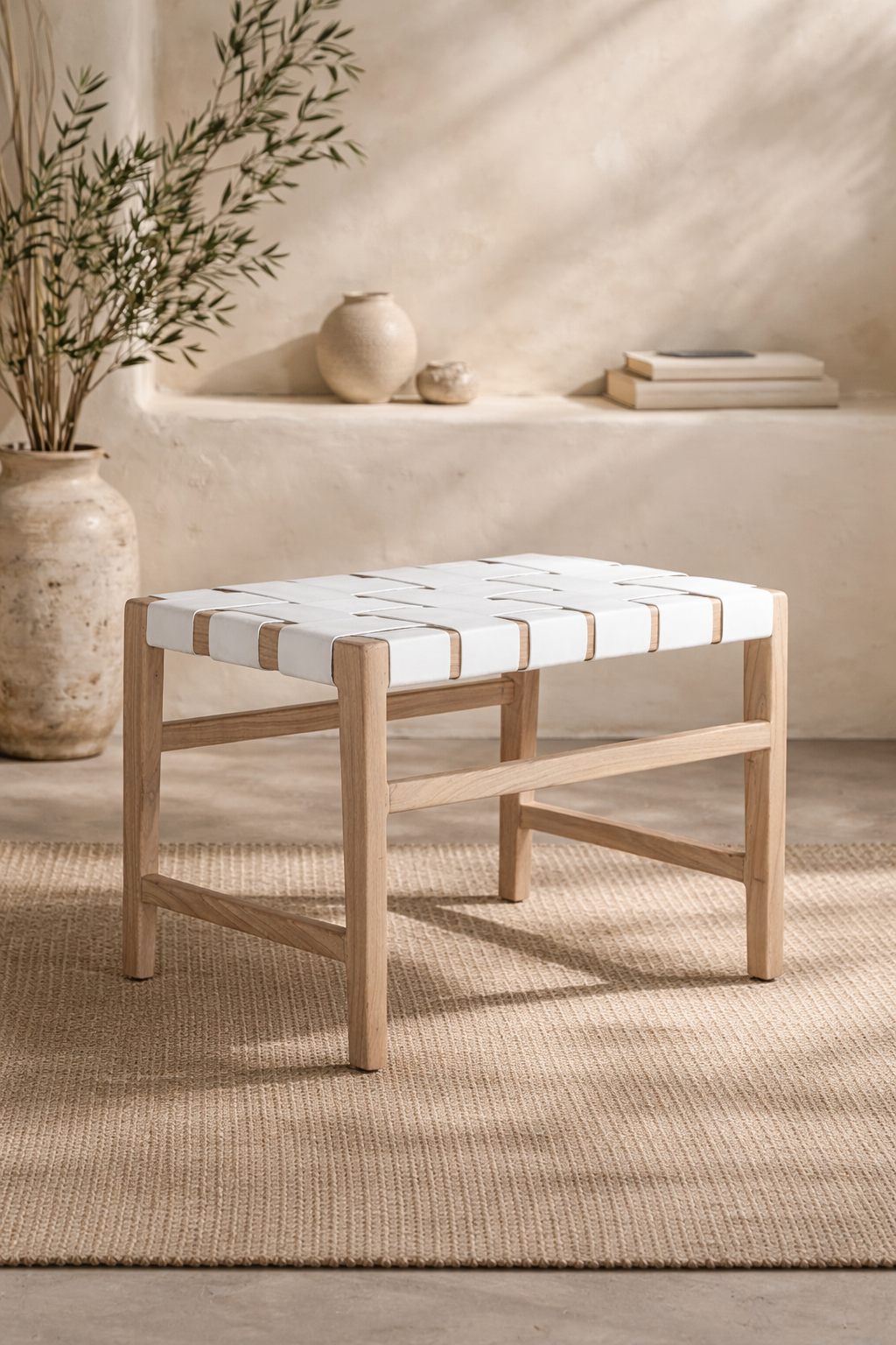 Lazzy low stool with natural timber frame and white woven seat, styled in a soft neutral interior with textured rug and warm organic decor.