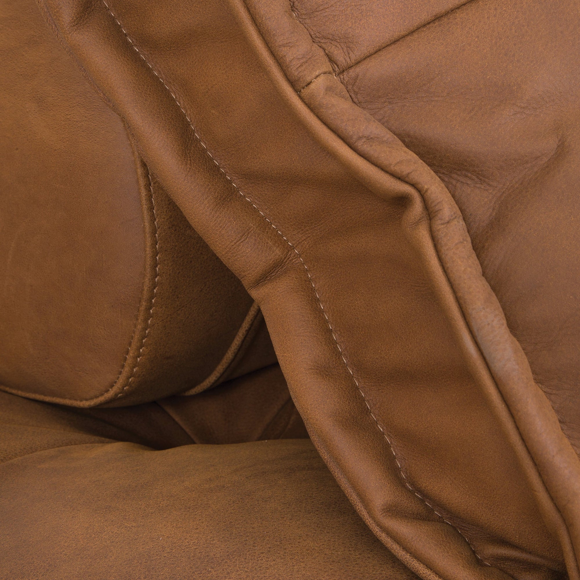 A stylish leather modular sofa with a low-profile design and plush cushioning, offering a relaxed and contemporary seating option for modern interiors