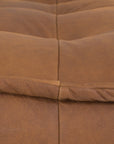 A stylish leather modular sofa with a low-profile design and plush cushioning, offering a relaxed and contemporary seating option for modern interiors