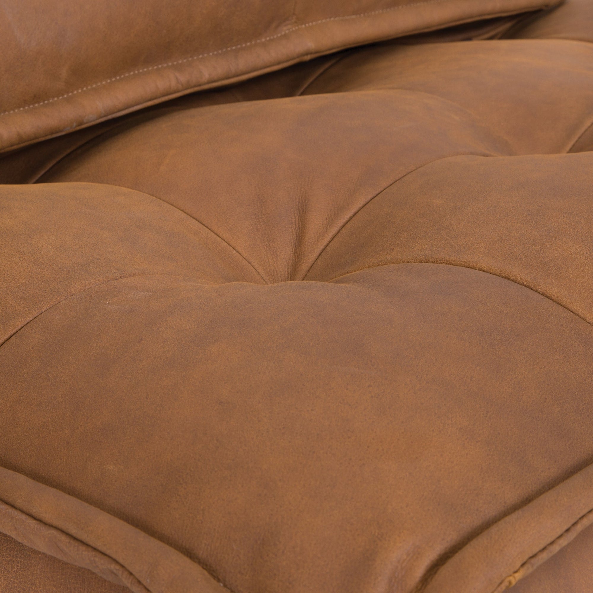 A stylish leather modular sofa with a low-profile design and plush cushioning, offering a relaxed and contemporary seating option for modern interiors