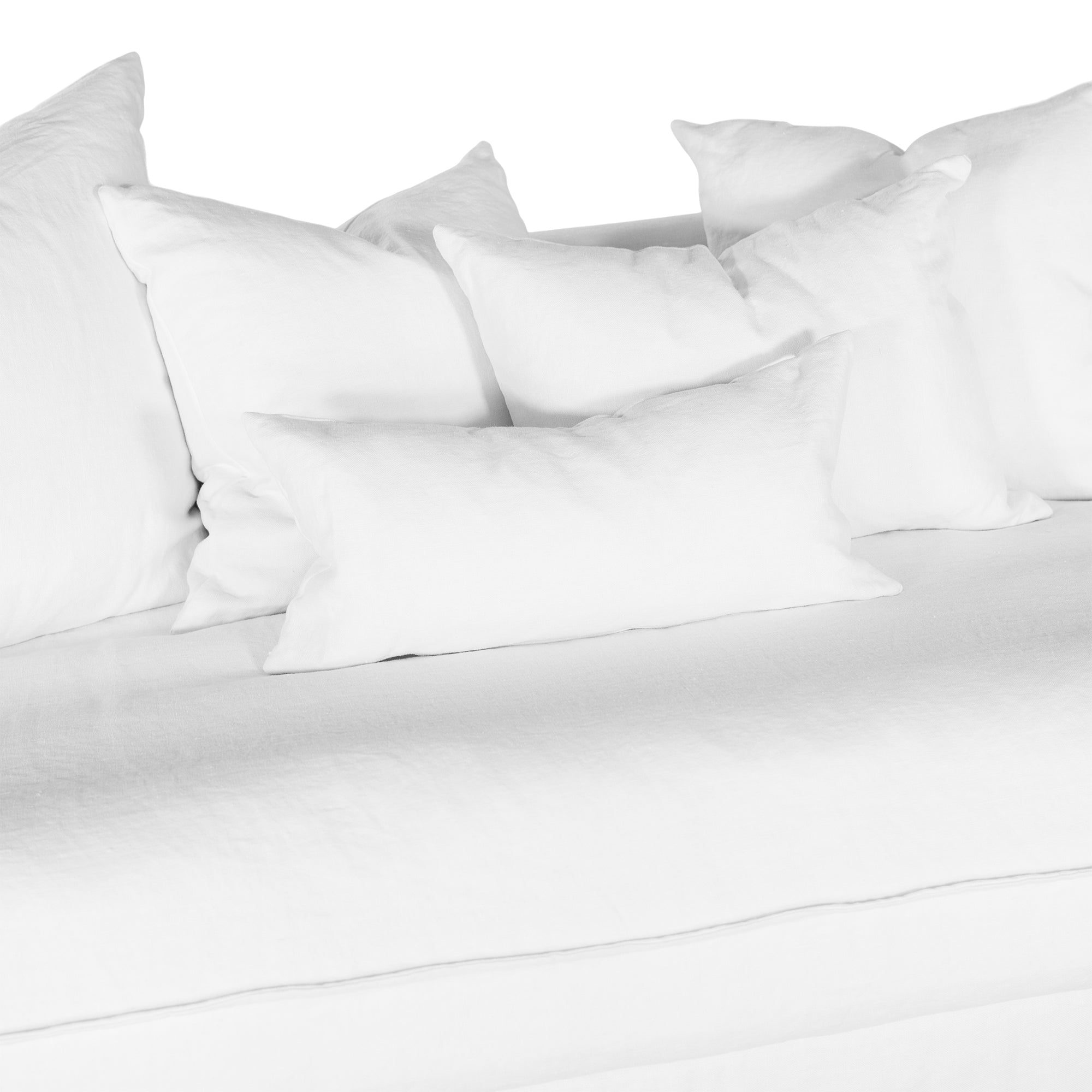 White linen three seater sofa with plush cushions, featuring a relaxed and stylish design for effortless comfort