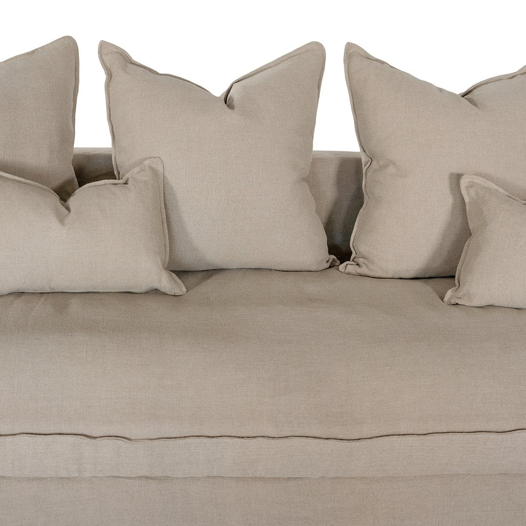 Linen slipcover sectional sofa, designed for effortless comfort and relaxed elegance. Features a modular design with plush cushions and a timeless neutral hue