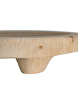 Lumara cheese plate in solid natural wood with round profile, visible timber grain and low pedestal feet.