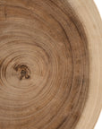 Lumara cheese plate in solid natural wood with round profile, visible timber grain and low pedestal feet.