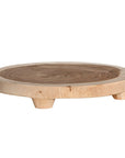 Lumara cheese plate in solid natural wood with round profile, visible timber grain and low pedestal feet.