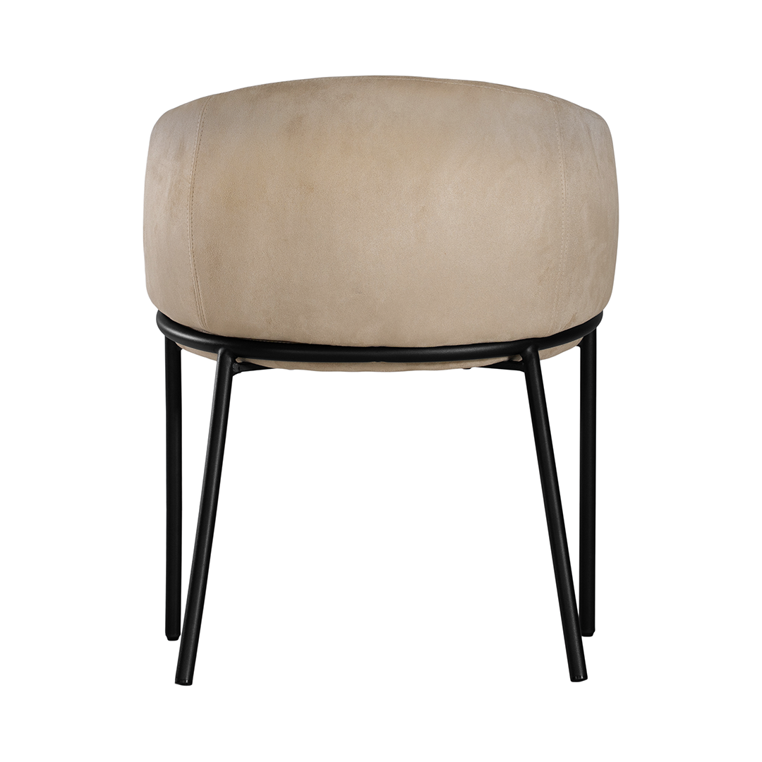 Lumo dining chair in bone with soft upholstered seat and curved backrest on slim black legs shown in a clean minimal setting.