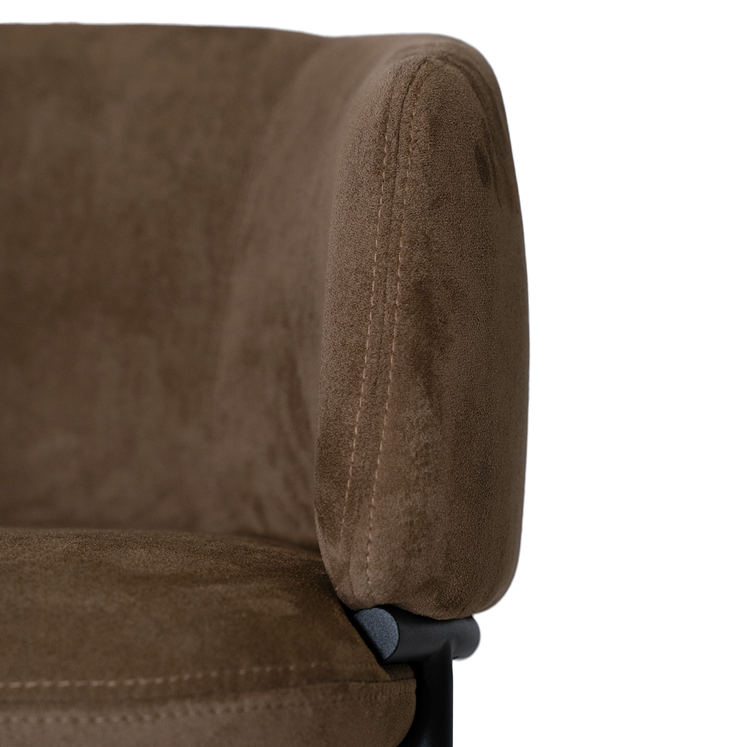Lumo dining chair in cocoa with soft upholstered seat and curved backrest on slim black legs shown in a clean minimal setting.