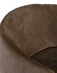 Lumo dining chair in cocoa with soft upholstered seat and curved backrest on slim black legs shown in a clean minimal setting.