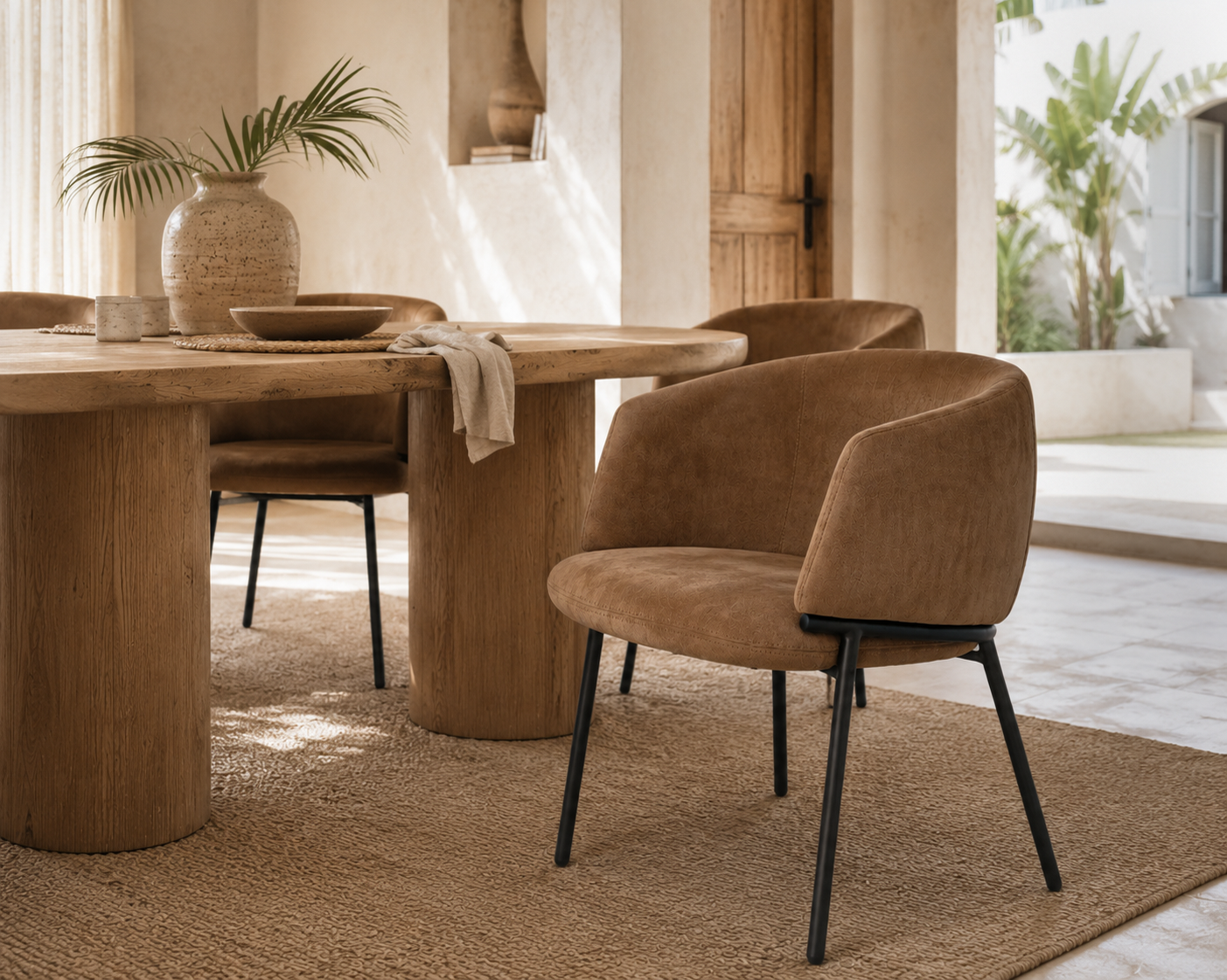 Lumo Dining Chair in cognac leather adds warmth and refined comfort to a relaxed Mediterranean inspired dining space