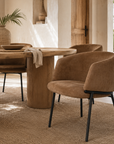 Lumo Dining Chair in cognac leather adds warmth and refined comfort to a relaxed Mediterranean inspired dining space