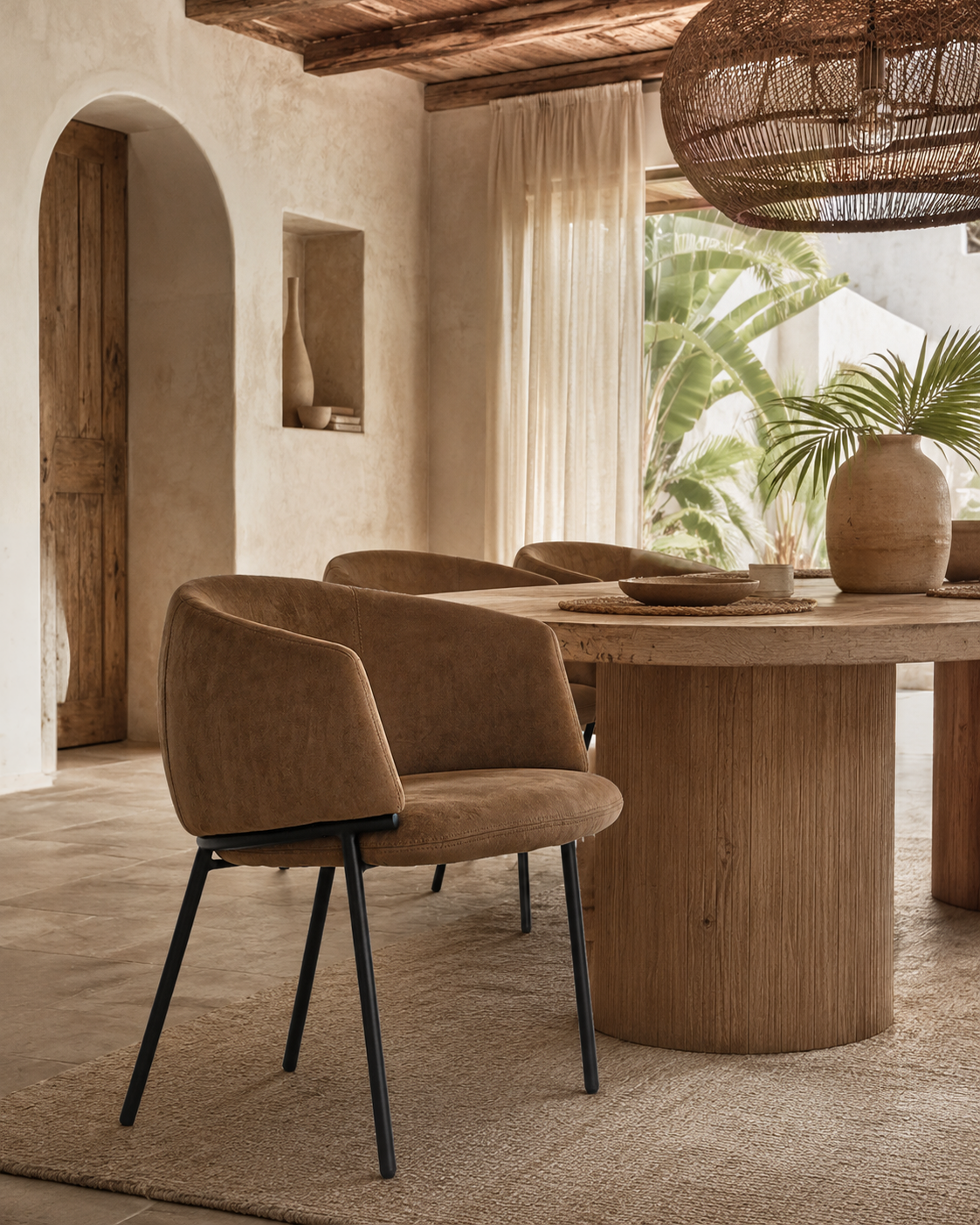 Lumo Dining Chairs in cognac leather bring warmth and texture to a relaxed Mediterranean inspired dining space