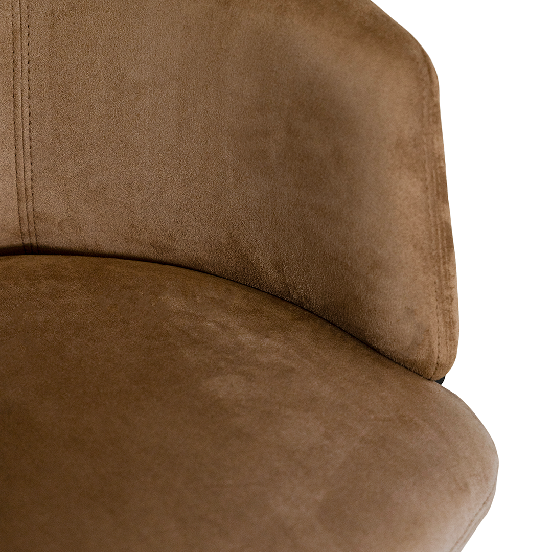 Lumo dining chair in hazelnut with soft upholstered seat and curved backrest on slim black legs shown in a clean minimal setting.