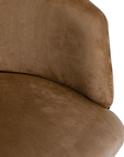 Lumo dining chair in hazelnut with soft upholstered seat and curved backrest on slim black legs shown in a clean minimal setting.