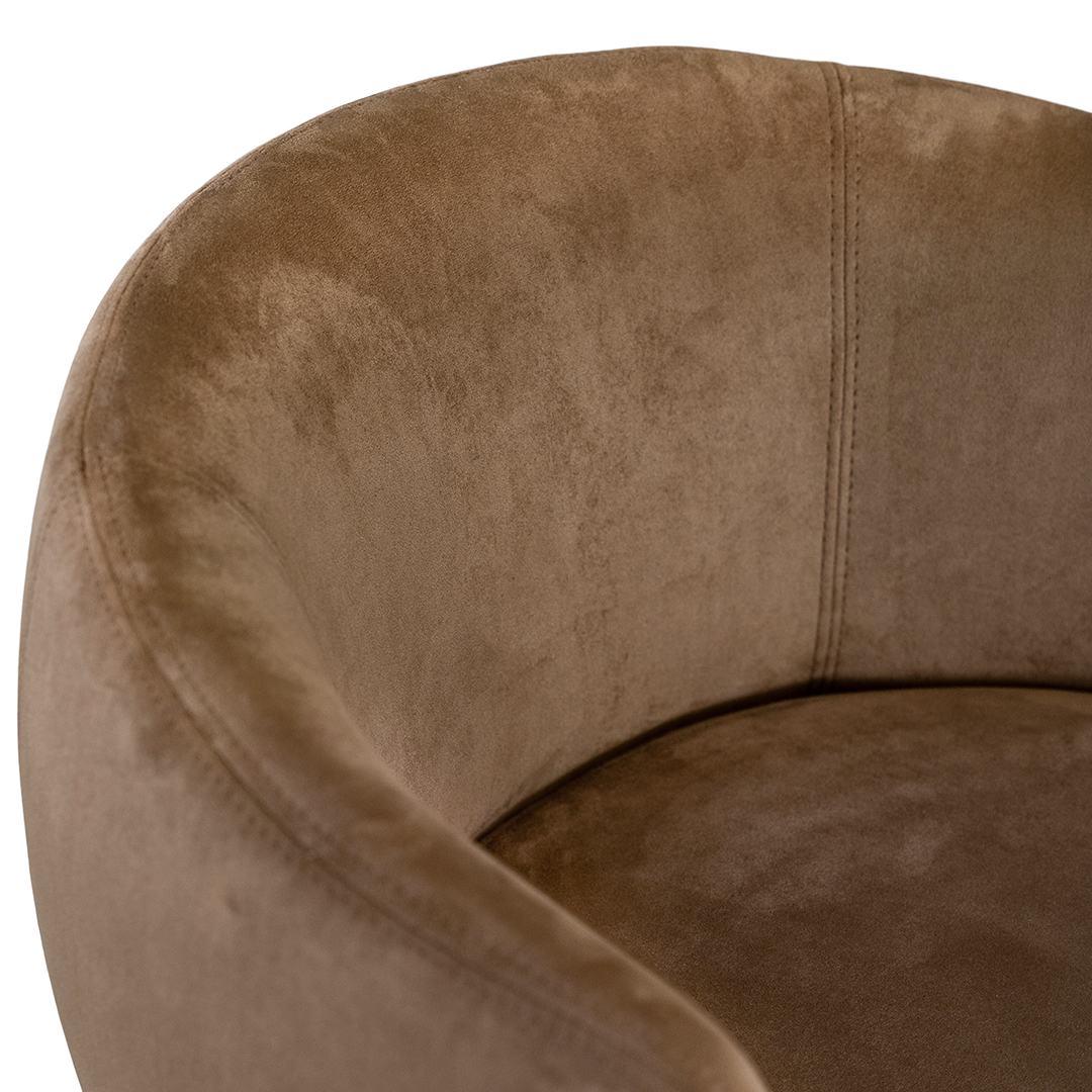 Lumo dining chair in hazelnut with soft upholstered seat and curved backrest on slim black legs shown in a clean minimal setting.