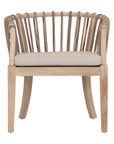 Makena chair in natural rattan with a linen seat cushion, featuring a curved backrest and sturdy timber frame, perfect for a relaxed dining setting