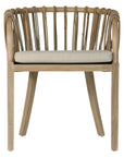 Makena chair in natural rattan with a linen seat cushion, featuring a curved backrest and sturdy timber frame, perfect for a relaxed dining setting