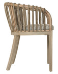 Makena chair in natural rattan with a linen seat cushion, featuring a curved backrest and sturdy timber frame, perfect for a relaxed dining setting