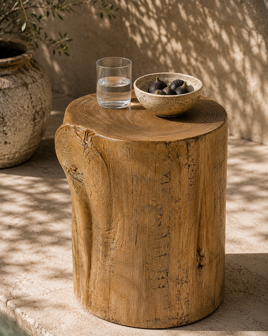 Natural Meera stool crafted from magnesium oxide styled beside a poolside daybed creating a warm organic retreat with rustic character and natural textures.