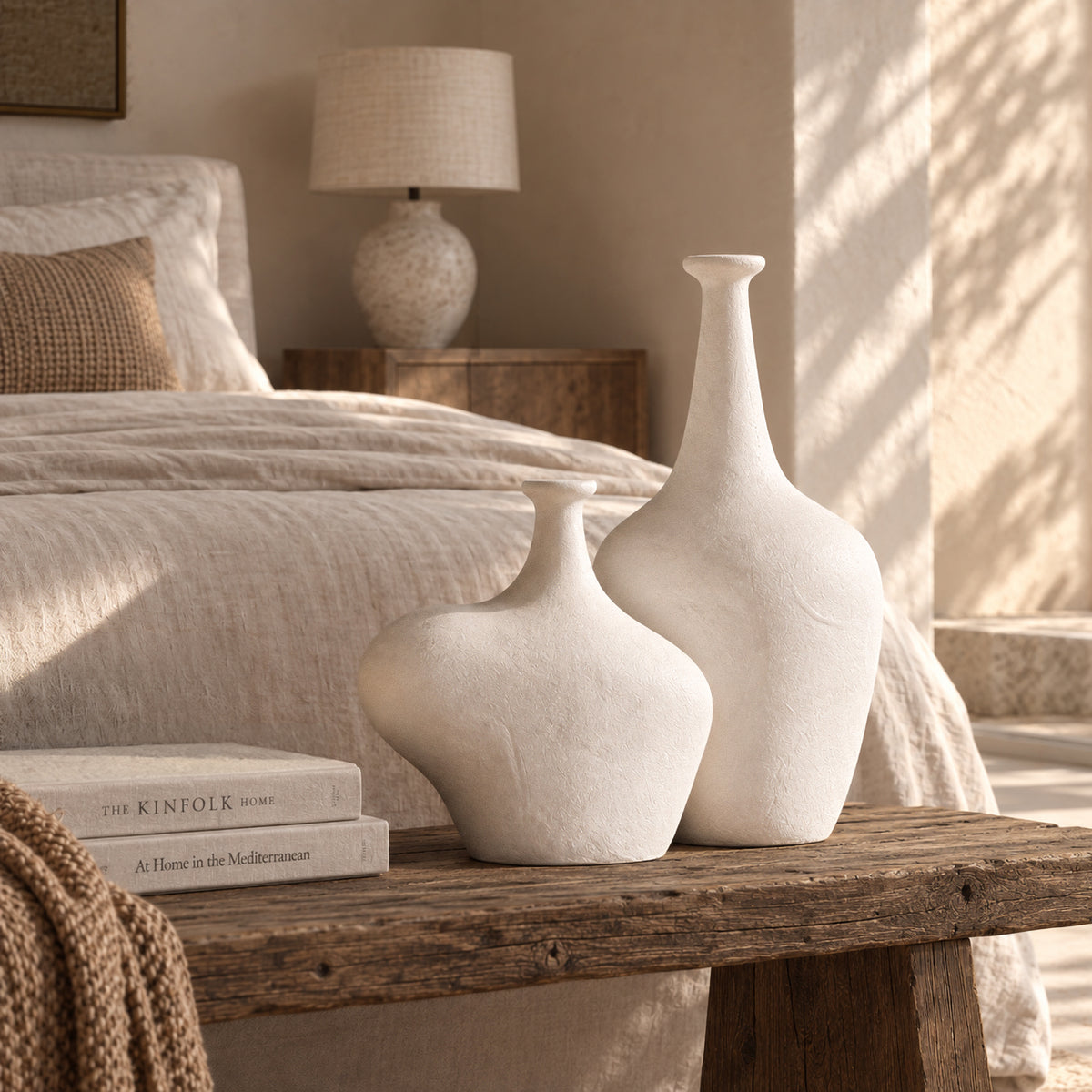KULALA Living Meraki whitewashed fibre cement vases styled on a rustic timber bench in a warm neutral bedroom.