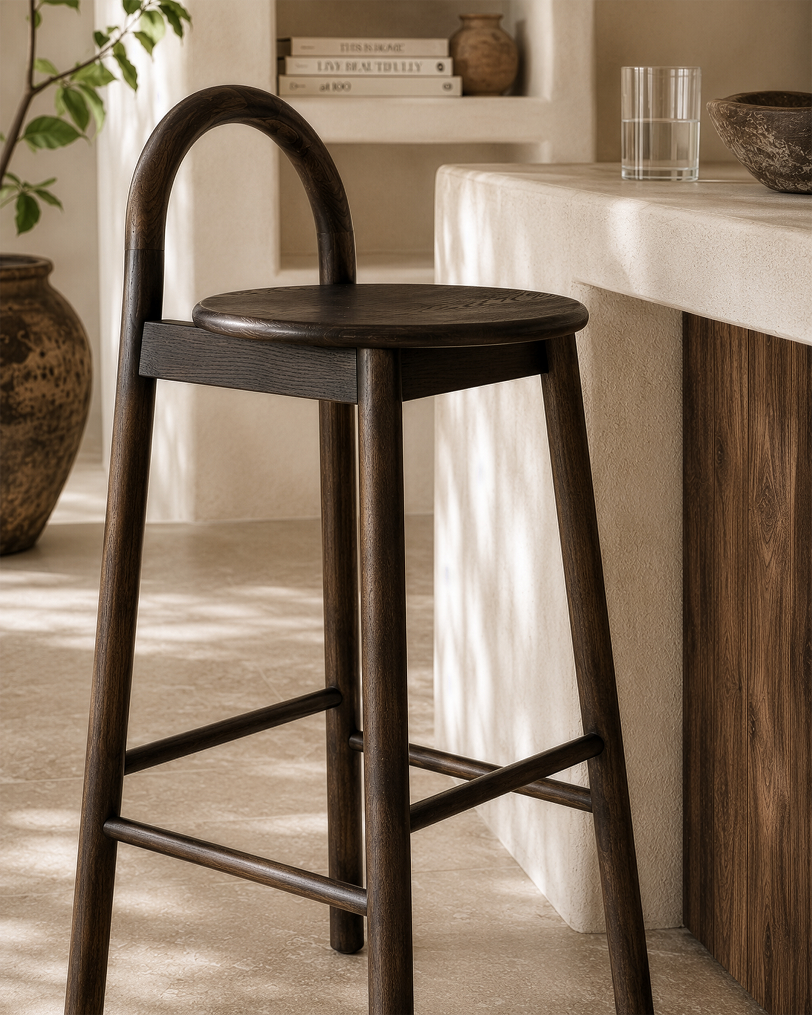 Milo barchair in espresso finish styled beside a textured stone island creating a warm refined kitchen setting with natural earthy tones.