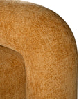 A luxurious mustard lounge chair with a sculptural, curved backrest and a matching ottoman, offering a bold yet elegant statement piece for contemporary interiors.