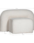 A luxurious white lounge chair with a sculptural, curved backrest and a matching ottoman, offering a bold yet elegant statement piece for contemporary interiors