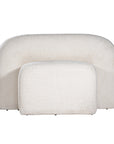 A luxurious white lounge chair with a sculptural, curved backrest and a matching ottoman, offering a bold yet elegant statement piece for contemporary interiors