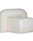 A luxurious white lounge chair with a sculptural, curved backrest and a matching ottoman, offering a bold yet elegant statement piece for contemporary interiors