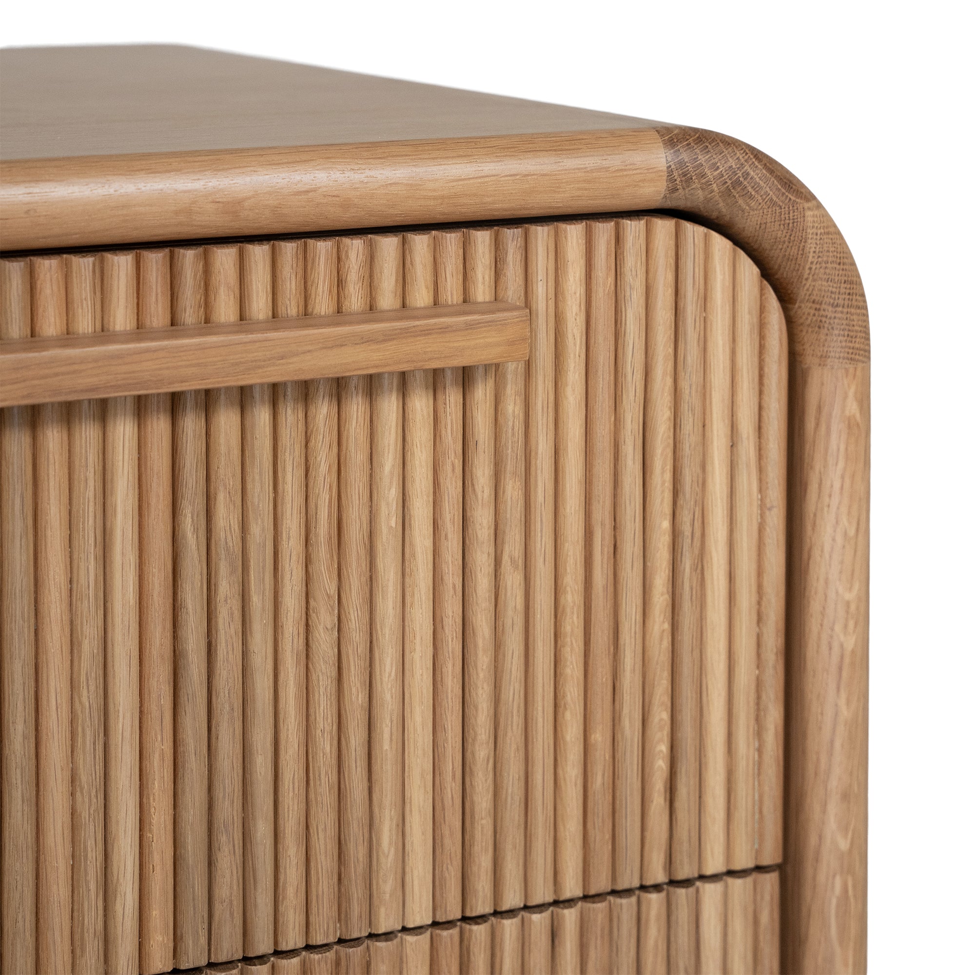 A modern oak bedside table from KULALA Living, featuring a curved silhouette and storage drawers. Crafted from natural wood, this minimalist piece enhances any bedroom with its warm, organic aesthetic