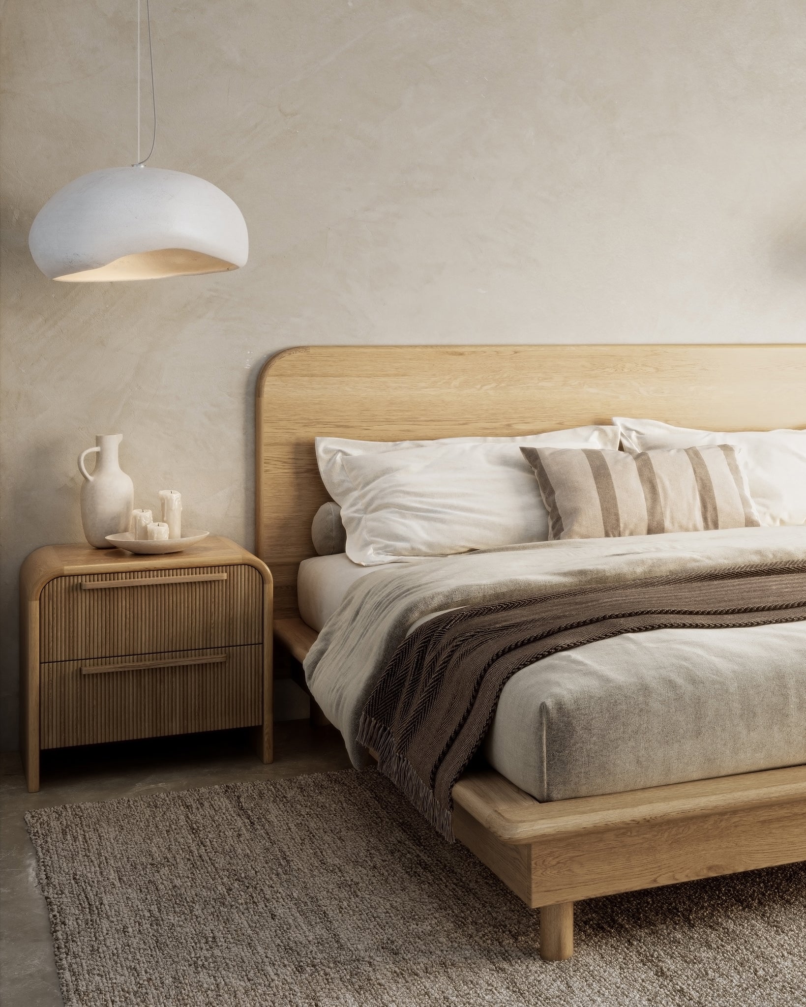A modern oak platform bed frame from KULALA Living, styled in a serene bedroom setting with arched walls, soft lighting, and natural textures. Complemented by neutral bedding, rattan bedside tables, and pendant lights for a refined, minimalist aesthetic