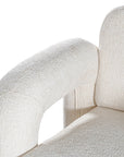 A modern sculptural armchair with rounded, chunky arms and backrest, upholstered in soft white boucle fabric, perfect for contemporary living spaces