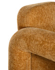 A modern sculptural armchair with rounded, chunky arms and backrest, upholstered in mustard boucle fabric, perfect for contemporary living spaces