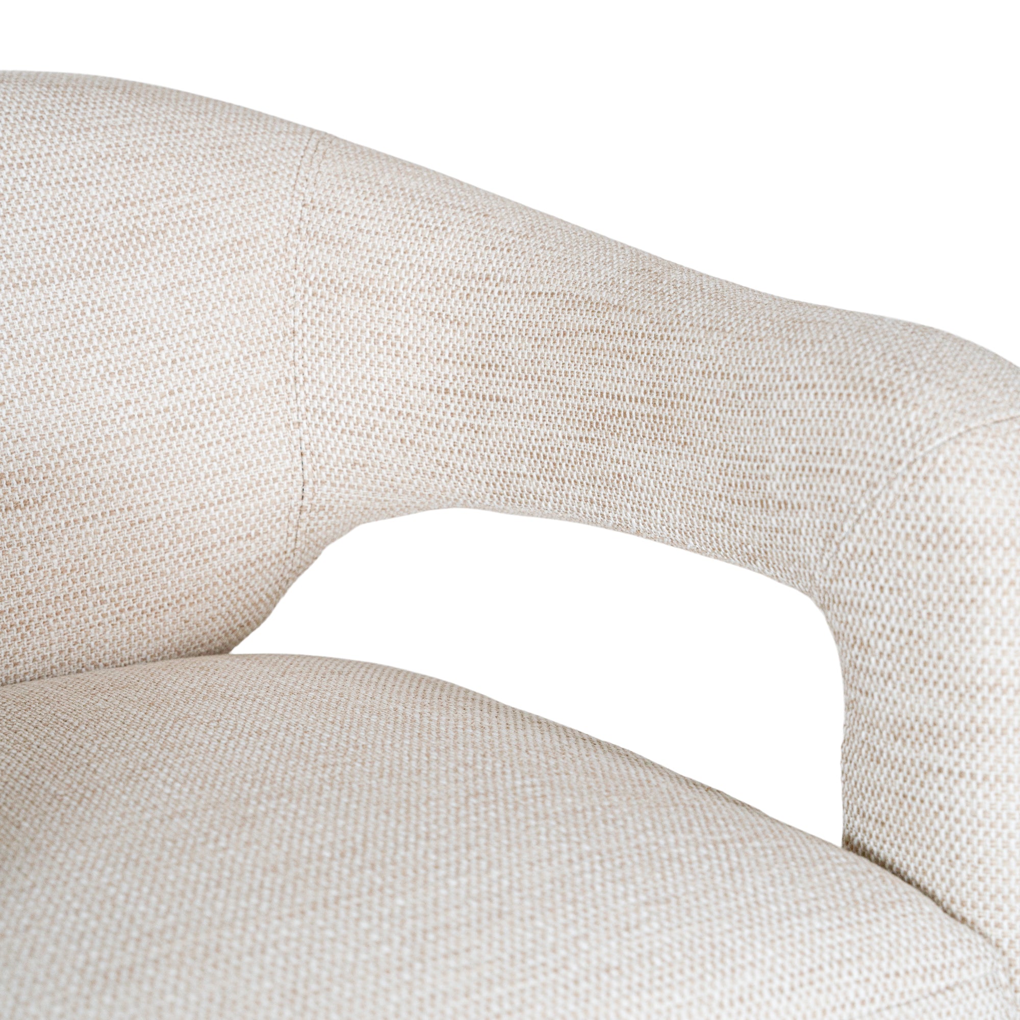 Contemporary upholstered armchair in a soft beige fabric, featuring a sculptural curved frame and plush seating for a modern, sophisticated look.