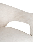 Contemporary upholstered armchair in a soft beige fabric, featuring a sculptural curved frame and plush seating for a modern, sophisticated look.