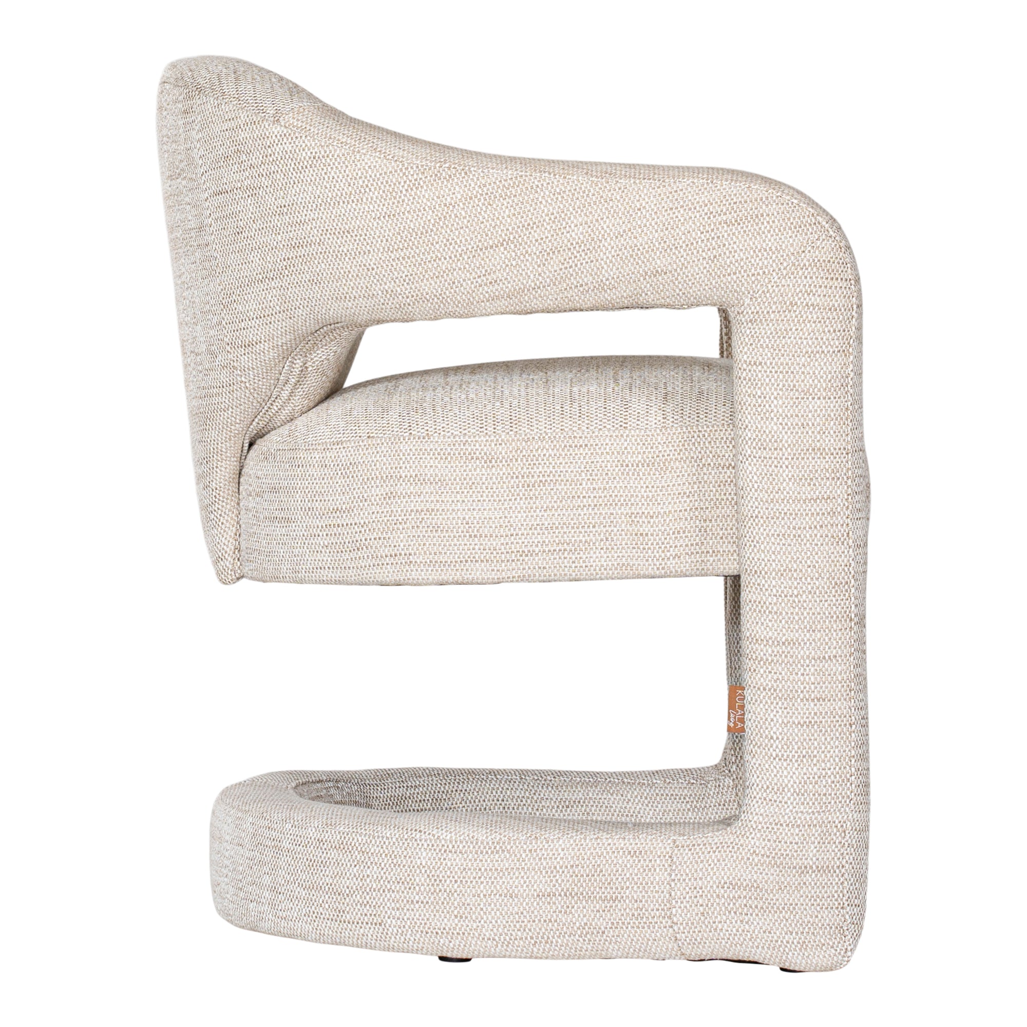 Contemporary upholstered armchair in a soft beige fabric, featuring a sculptural curved frame and plush seating for a modern, sophisticated look.